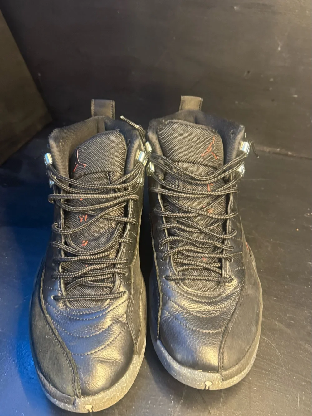Men's Jordan 12 Black High-Top Athletic Sneakers with Subtle Orange Accent